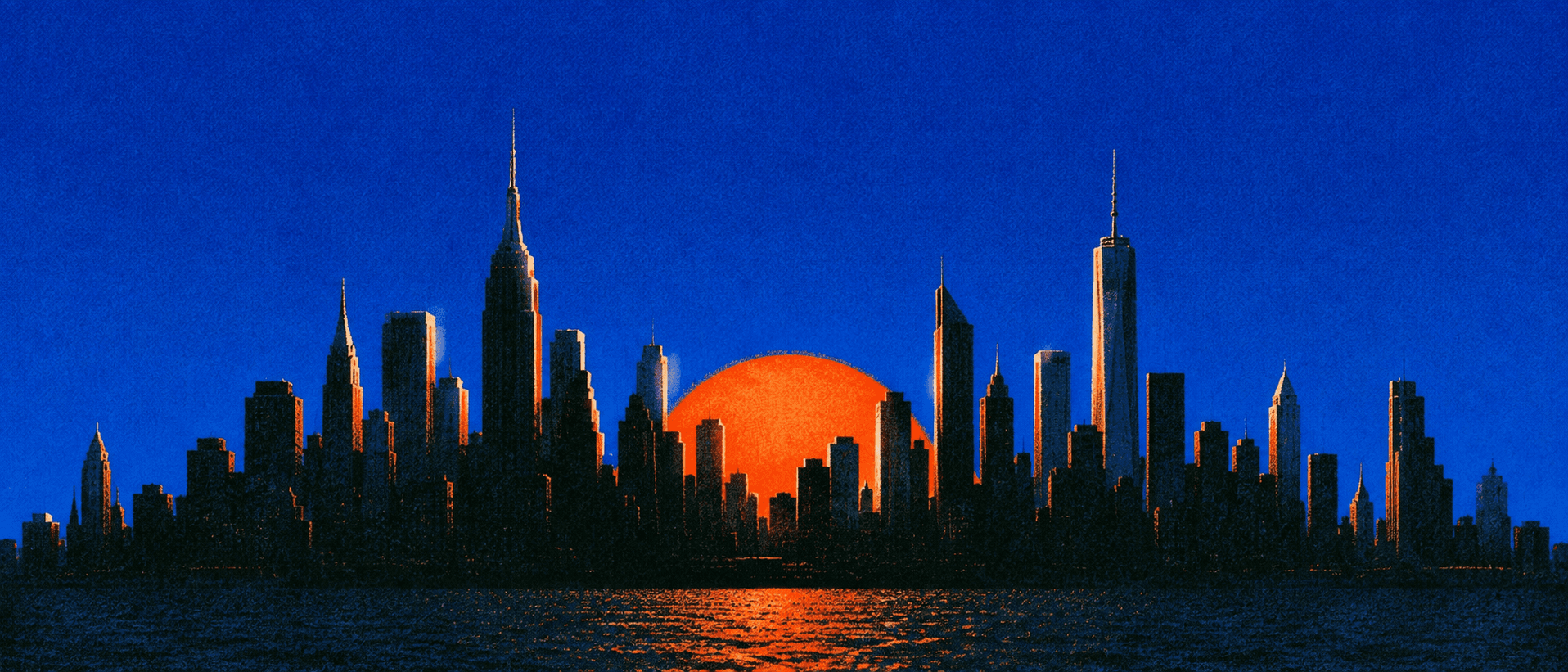 The Manhattan skyline in silhouette against a deep blue sky, a red sun setting behind the towers over the water