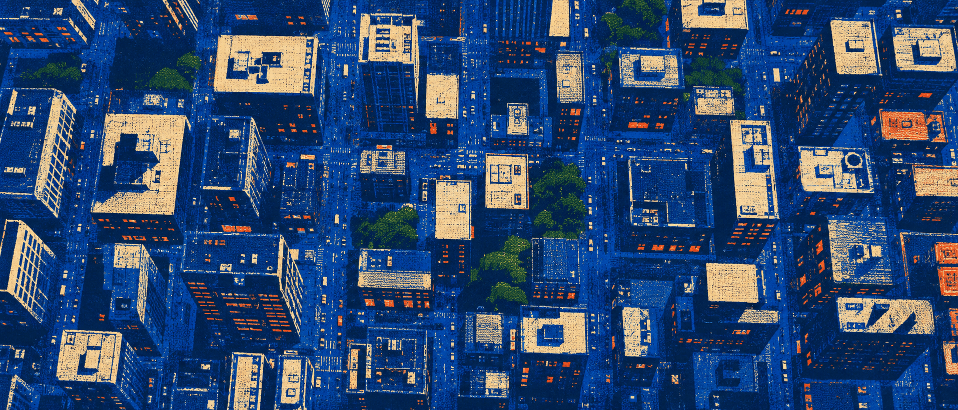 A city block grid seen from directly above, rooftops catching low orange light