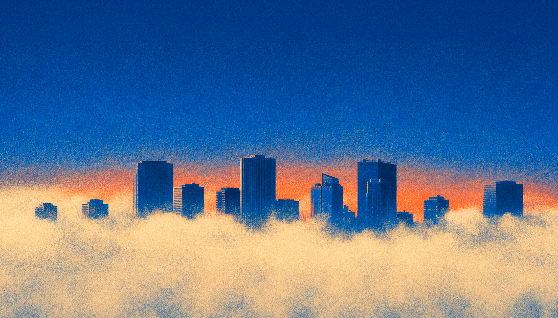 A dense city seen from above at dusk, windows lit across the blocks